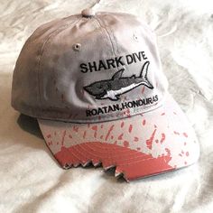 Grey Children’s Ball Cap Style Hat With Adjustable Velcro Back. Simulated Shark Bite Out Of The Bill Of The Hat. Embroidery On The Front Says Shark Dive (Great White) Roatan, Honduras. Purchased In Roatan, With The Tag As Is, But Never Worn. Shark Things, Shark Clothes, Shark Stuff, Shark Hat, Roatan Honduras, Cute Shark, Shark Bites, Hat Embroidery