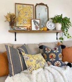 a living room filled with lots of pillows and decor