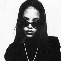 a woman wearing sunglasses and a necklace