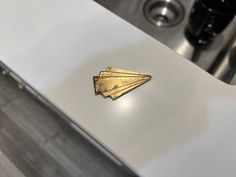 a metal object sitting on top of a white counter