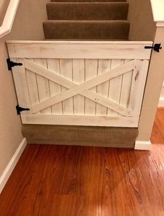 an open barn door on the side of a staircase leading up to a set of stairs