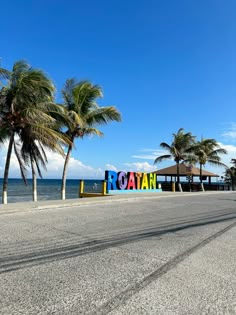 there is a large sign that says vacation on the beach with palm trees in front of it