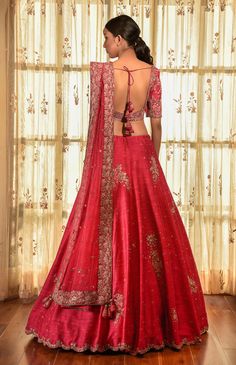 Editor's Note This set features an imperial red raw silk kalidar lehenga with thread and tilla butas, paired with a raw silk blouse and a tulle dupatta with border. Fabric: Raw silk and tulle Color: Red Components: Lehenga, blouse and dupatta Occasion: Wedding Disclaimer: Product color may slightly vary due to photographic lighting sources or your monitor setting. Care: Dry clean only About the Designer Dolly J is an Indian occasion wear label known for their modern take on traditional silhouett Silk Lehenga Designs Latest, Dolly J, Raw Silk Blouse, Indian Bridesmaid Dresses, Raw Silk Lehenga, Wedding Lehenga Designs, Lehenga Designs Simple, Bridal Lehenga Collection, Lehenga Blouse Designs