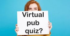 a woman holding up a sign that says virtual pub quiz? on it, against a blue background