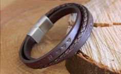 Handmade Leather Bracelet with Engraved Text in the Leather. The Leather bands on this Men's Bracelet can be personalized with a text, we will engrave your text in the leather with our laser engraving machine. The clasp of this bracelet can be engraved with a text and/or image of your choosing. In the photo's of this listed item you can see which images we can engrave on the clasp for you. If you don't see an image you like, but would still like to have an image engraved, you can always reach ou Handmade Leather Friendship Bracelets, Leather Bracelet Jewelry For Gifts, Father's Day Leather Strap Bracelet Gift, Brown Hand Stamped Bracelets For Everyday, Father's Day Gift Bracelet With Leather Strap, Everyday Brown Hand Stamped Bracelet, Personalized Leather Bracelets For Anniversary, Stamped Leather Bracelet As Gift, Personalized Brown Leather Bracelets