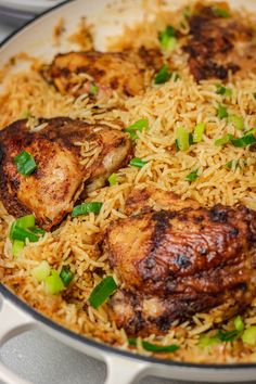 chicken and rice in a skillet with green onions on the side, ready to be eaten