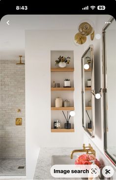 a bathroom with white walls and open shelvings on the wall above the sink