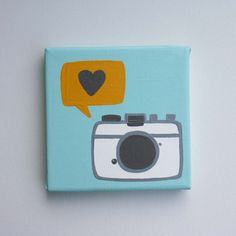 a painting of a camera with a speech bubble above it that says i love you