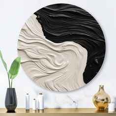 a black and white abstract painting on a wall next to vases with plants in them