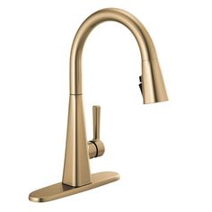 a kitchen faucet with the pull out sprayer in brushed brass finish, on an isolated white background