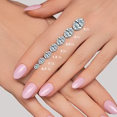 a woman's hand with pink nail polish and diamond ring on it, next to her measurements