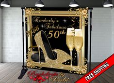 a black and gold 50th birthday backdrop with high heels