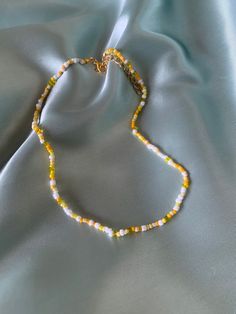 Handmade yellow beaded necklace! The whole length of the necklace (including extension) is approximately 45cm. If you have any questions, please message me! Yellow Necklace Bead, Yellow Bead Necklace, Yellow Round Bead Necklaces For Summer, Trendy Yellow Round Bead Necklaces, Trendy Yellow Necklaces With Round Beads, Trendy Yellow Beaded Chain Necklace, Tiny Yellow Beads For Summer, Trendy Yellow Round Beads Necklaces, Trendy Yellow Necklace With Beaded Chain