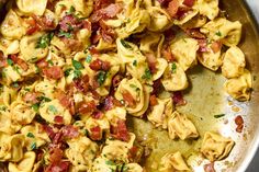 a pan filled with pasta covered in bacon and cheese