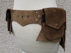 Suede festival utility belt perfect for the dancefloor or travelling.   Light Brown  colour This belt is adjustable from 33 - 39 inch (84 - 100 cm)  It has 5 pockets which close with zips  Pocket sizes Front 2 zip pockets    19 x 11cm        (fits all phones )   2 zip pocket      12 x 11 cm     Back 1 zip pocket   15 x 11 cm          Comes in a unique gift bag I can now send with Mondial Relais to France 4,99€ , Belgium 5,99€ , Netherlands 6,99€ , Portugal Spain 8,99€ . This service is to a pick Brown Belt Bag For Festival, Bohemian Belt Bag With Belt Loops For Festivals, Light Brown Colour, Utility Belt, Brown Colour, Hip Bag, Brown Color, Gift Bag, Light Brown