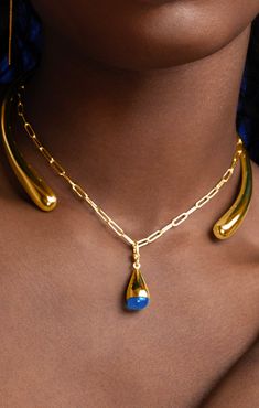 Modern and minimalist, this sculptural set features a gradient, open-ended shape. Wear to make a simple yet stunning statement. Handcrafted in recycled brass by artisans in Kenya. Gold products are 24k gold plated brass and match our brass style in color and tone. Your purchase promotes artisan innovation + entrepreneurship. Dimensions: Glass bead dimensions: 0.39in x 0.90in (10mm x 23mm) Chain length: 18.11in (460 mm) Jewelry Gold Modern, Modern Jewelry Necklaces, Gold Teardrop Necklaces Hand Forged, Gold Teardrop Hand Forged Necklace, Innovation And Entrepreneurship, Gold Collar Necklace, Shape Wear, Open Ended, Necklace Charm