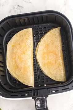 two tortillas are being cooked in the air fryer