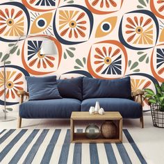 a living room scene with focus on the couch and wallpaper that has an abstract design