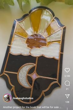 a stained glass sun catcher hanging on the wall