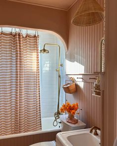 a bath room with a toilet a sink and a tub