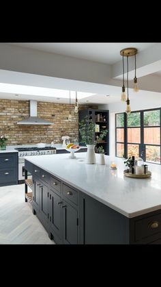 a large kitchen with an island in the middle and lots of cabinets on both sides