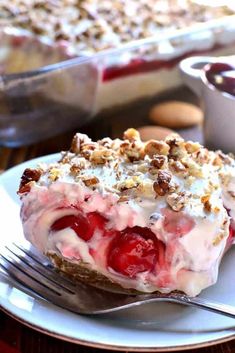 a piece of pie on a plate with a fork next to it and another dish in the background