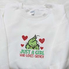 Just A Girl Who Loves Grinch Embroidered Shirt, Christmas Embroidered Hoodie, Best Gifts For Family Nestled in the heart of fashion and festivity, Tinicloset is your ultimate destination for embracing the charm and whimsy of the holiday season. We’re not just a clothing store; we’re a gateway to a world where custom embroidered shirts, sweatshirts, T-shirts, and hoodies come to life, each stitch telling a story of love and adoration for all things merry and bright. And if you’r Hooded Tops With Machine Embroidery For Winter, Cute Winter Hoodie With Custom Embroidery, Cute Hoodie With Custom Embroidery For Winter, Long Sleeve Sweatshirt With Machine Embroidery As Gift, Cute Embroidered Graphics Hoodie For Winter, Cute Winter Hoodie With Embroidered Graphics, A Clothing Store, The Grinch Movie, Grinch Shirts