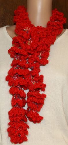 a red crocheted scarf on a mannequin