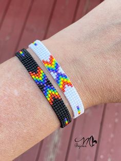 two bracelets with different colored beads on the wrist