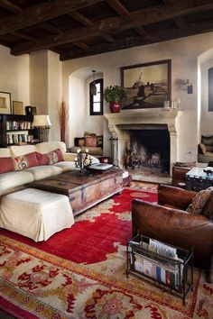 a large living room with couches, chairs and a fire place in it's center