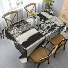 a table with two chairs and a black and white table cloth on top of it