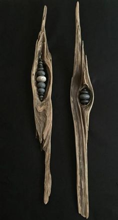 two pieces of wood that have been carved to look like branches with balls in them