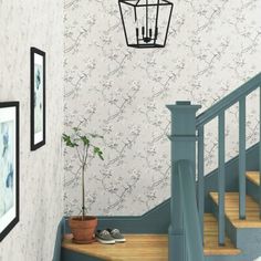 the stairs in this house are painted blue and have floral wallpaper on them, along with a small potted plant