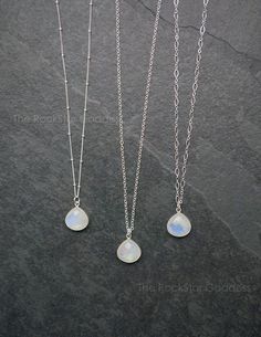 Moonstone gemstone pendant on a Sterling Silver chain. These Moonstone pendants are gorgeous with fire (iridescent flashes of color Moonstone is known for.) Customize your necklace in your preferred chain length. Select from 3 chain designs: cable, link or satellite.White moonstone facilitates spiritual growth. When you move these stones around often you will see beautiful colors reflected back at you, shimmering colors which may include scintillating shades of blue and purple.Your necklace will Celestial Moonstone Wire Wrapped Necklaces, Celestial Moonstone Wire Wrapped Necklace, Celestial Moonstone Necklace With Wire Wrapped Details, Celestial Wire Wrapped Moonstone Necklace, White Moonstone Crystal Necklace With Moon Charm, Moonstone Dangle Jewelry With Moon Charm, White Moonstone Jewelry With Moon Charm, Moonstone Teardrop Pendant For Healing, Mystical White Moonstone Necklaces