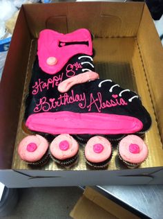 a birthday cake in the shape of a roller skate with pink frosting on top