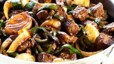 a bowl filled with meat and vegetables on top of a table