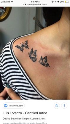 the back of a woman's shoulder with three butterflies on it