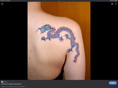 an image of a dragon tattoo on the back of a woman's shoulder