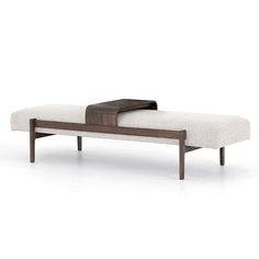 a wooden bench with a white upholstered cushion