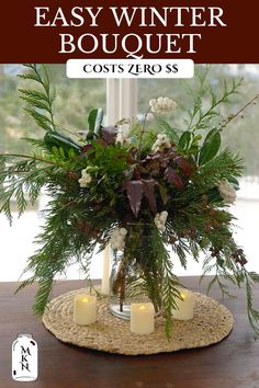 a vase filled with flowers and candles on top of a table