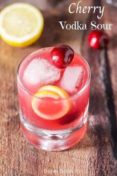 cherry vodka sour in a glass with ice and cherries