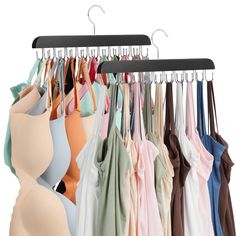 there are many different colored shirts hanging on the clothes hanger, and one is empty