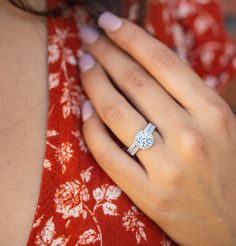 a woman's hand with a diamond ring on it