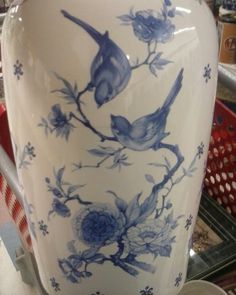 a blue and white vase sitting on top of a table