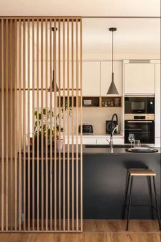 an open kitchen with wooden slats on the wall