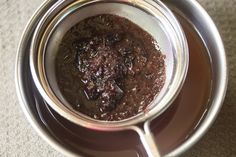 a cup filled with dirt sitting on top of a table