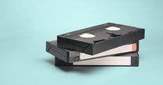 two floppy disks are stacked on top of each other, one is black and the other is white