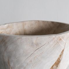 a wooden bowl sitting on top of a table