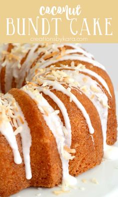 a bundt cake with white icing and coconut toppings on a white plate