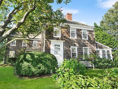 the house is surrounded by trees and bushes